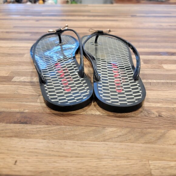Coach Landon jelly flip flops in black with a gold bow and white pattern. - Picture 7 of 12